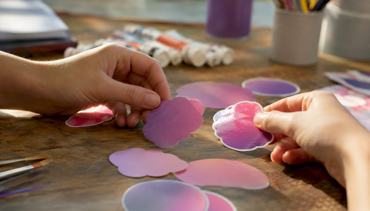 Hands placing matte and glossy die-cut stickers